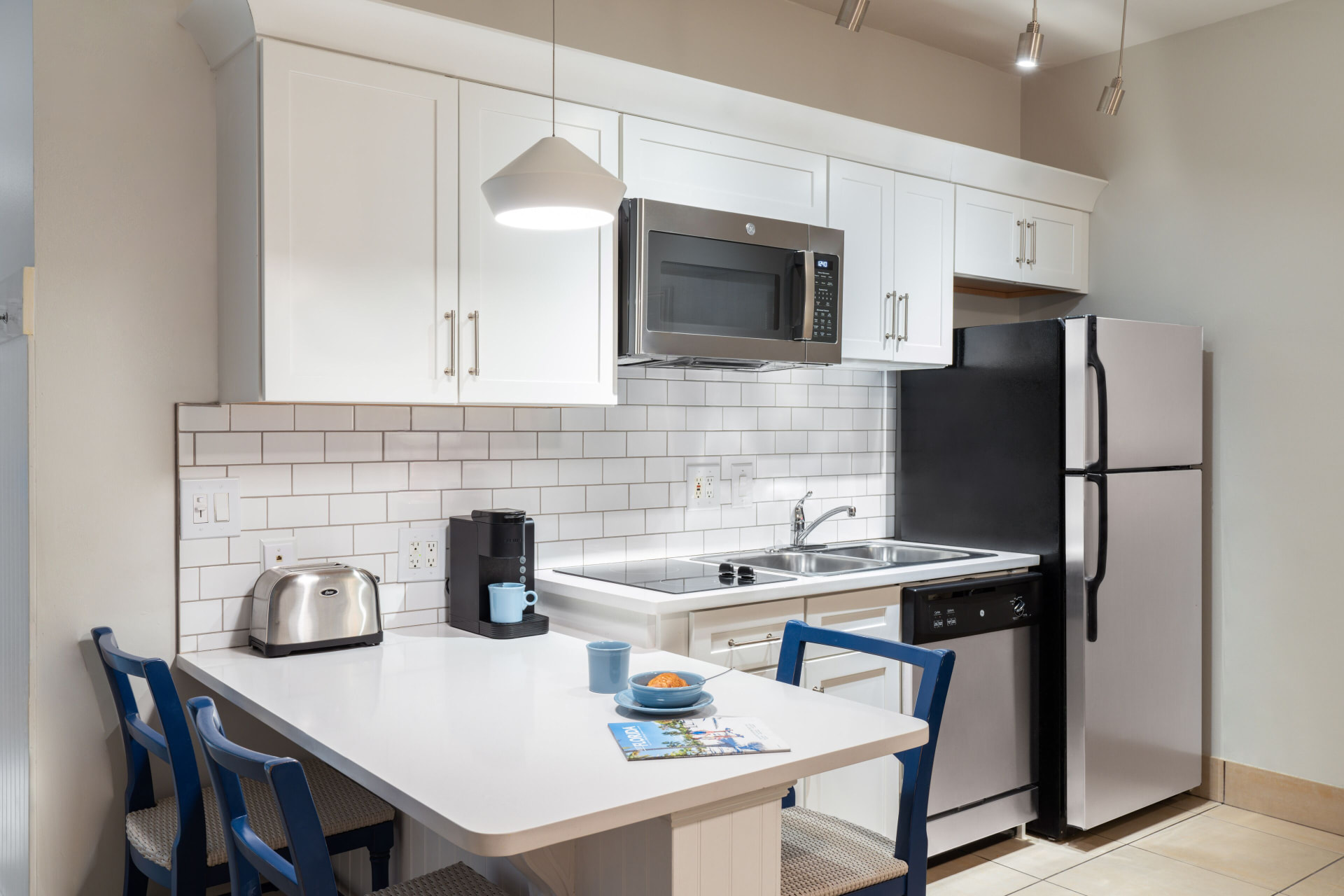 Studio suite kitchenette with dining table at Pink Shell Beach Resort