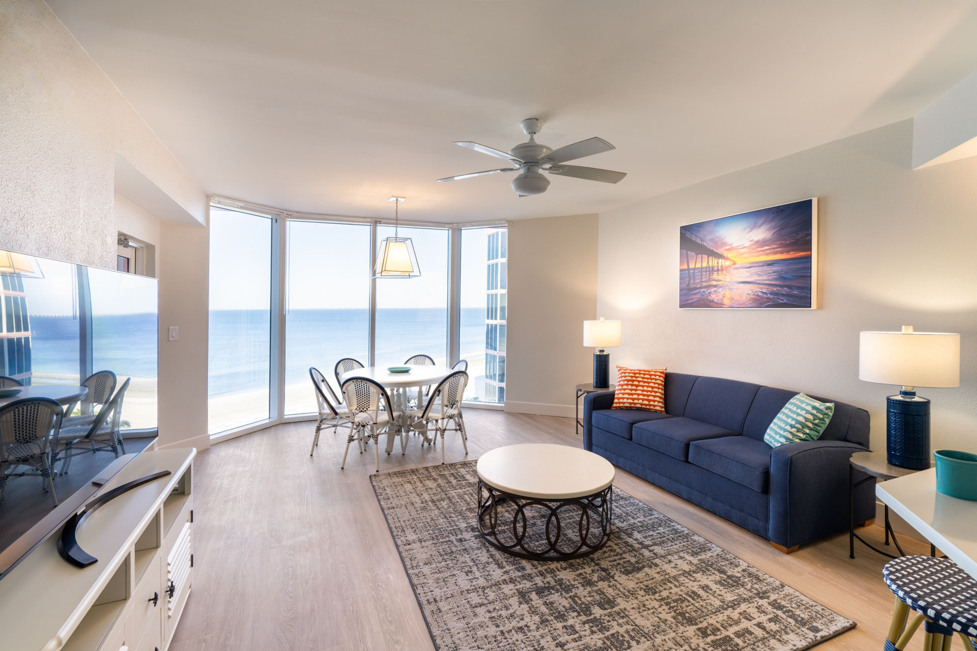 Beachfront suite living and dining area with floor-to-ceiling Gulf views at Pink Shell